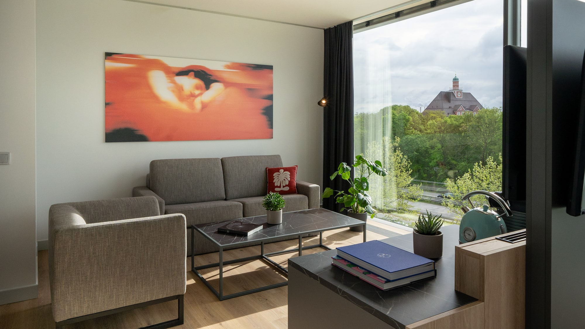 a living room with couches and a table and chairs