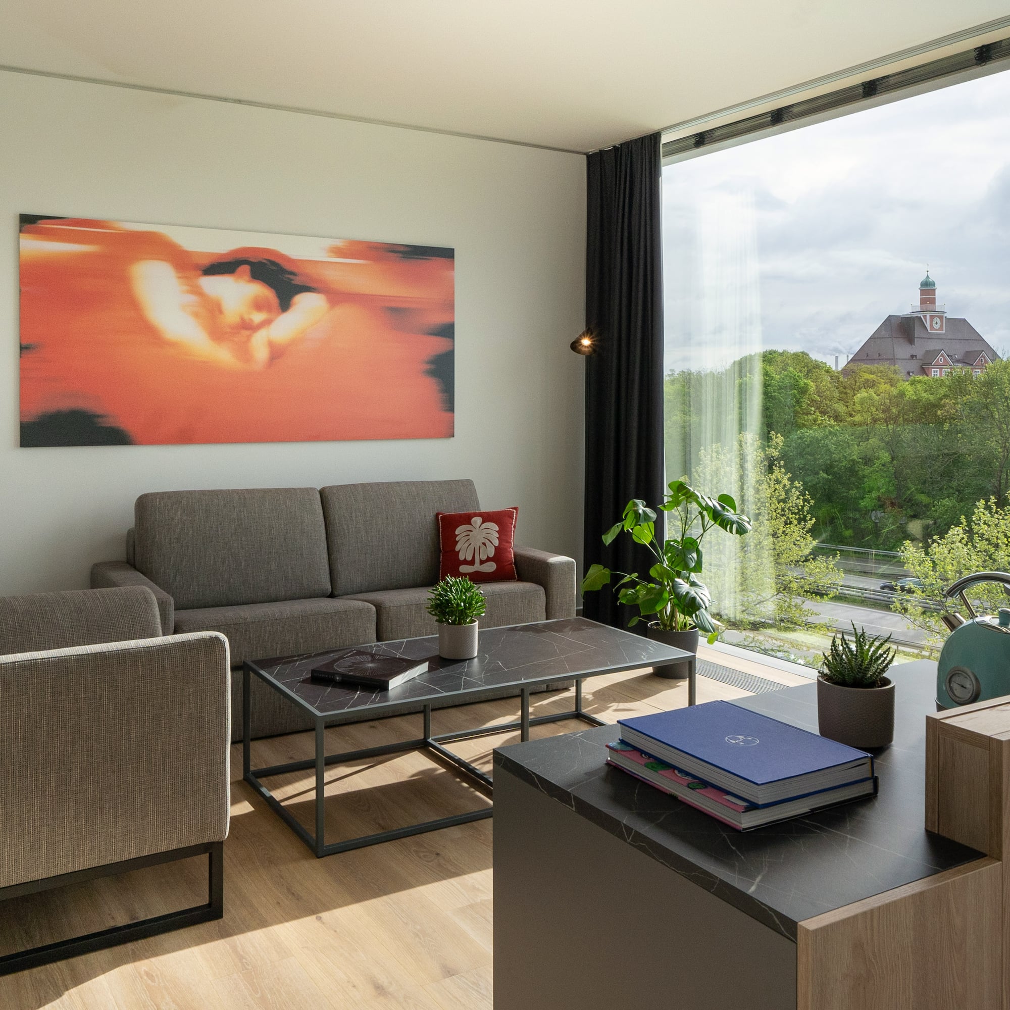 a living room with couches and a table and chairs