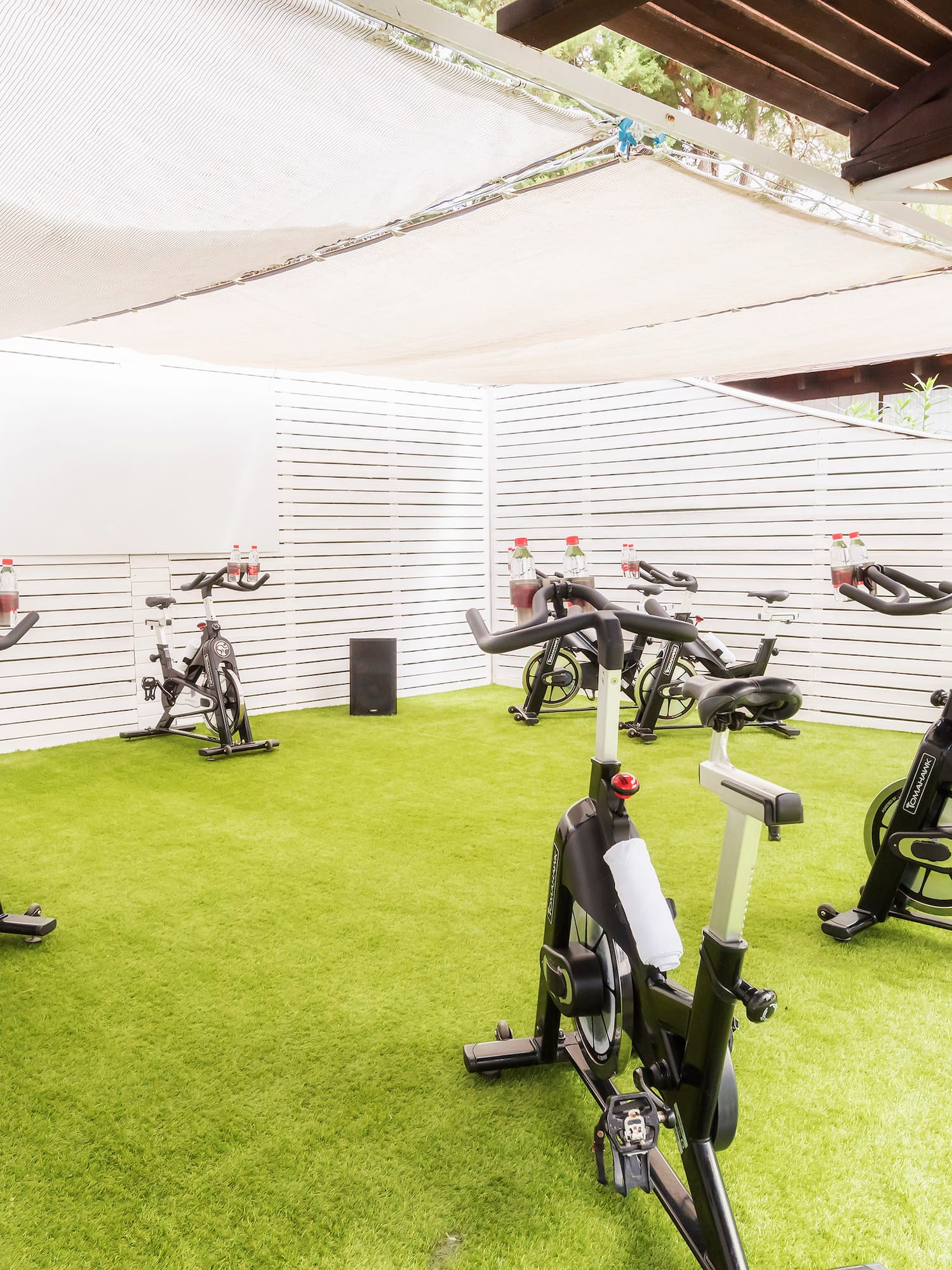 a group of exercise bikes on a green field