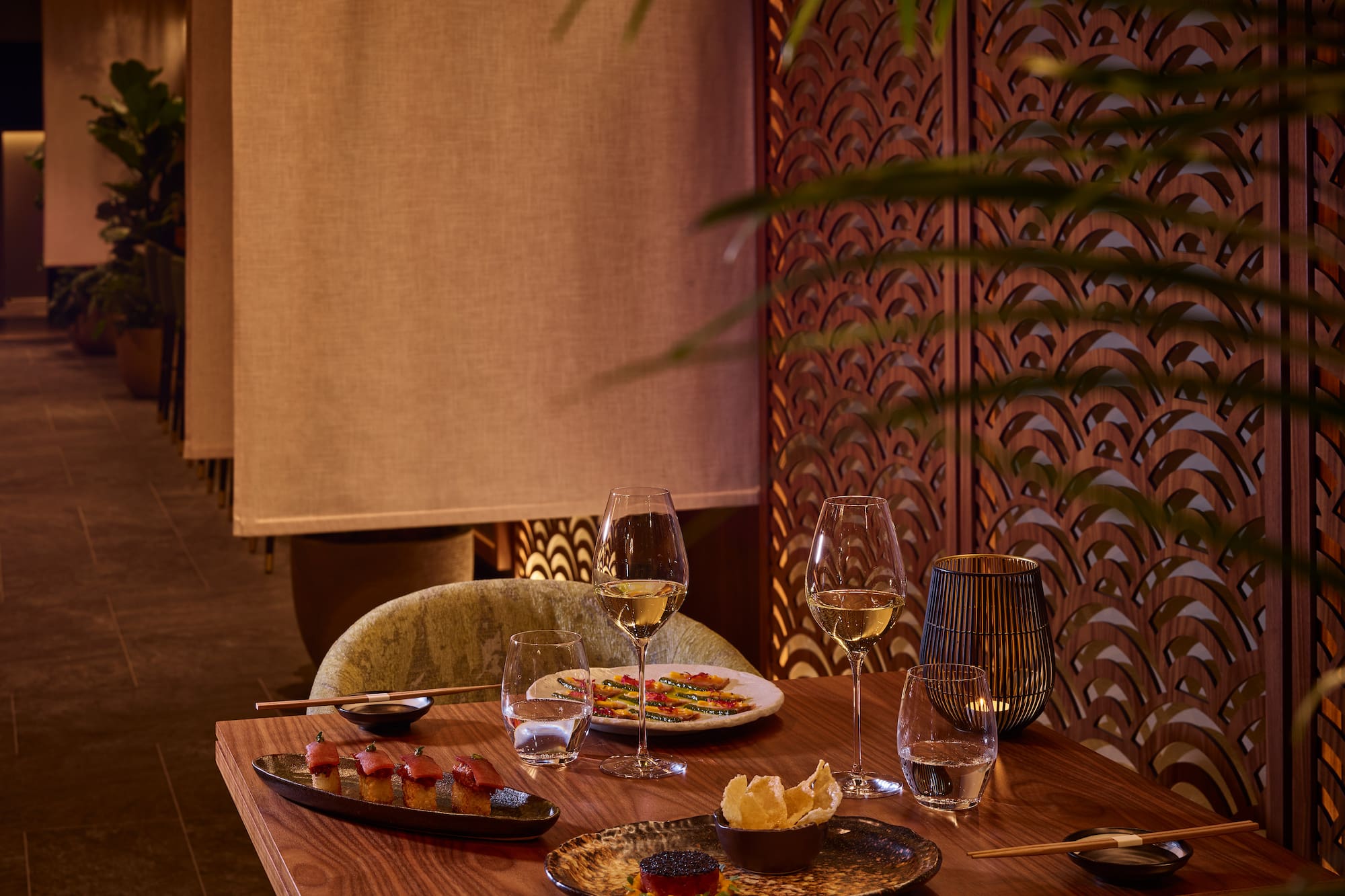 a table with plates of food and wine glasses