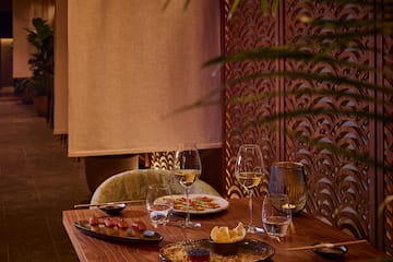 a table with plates of food and wine glasses