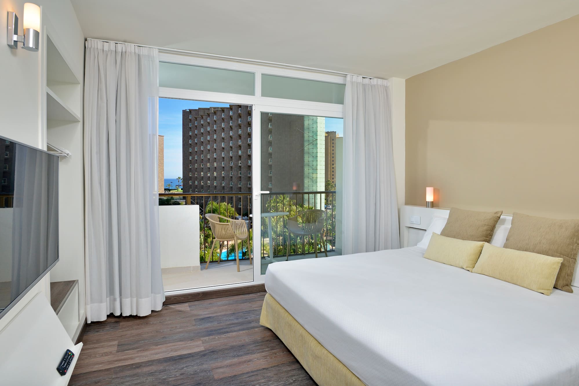 a bedroom with a balcony and a large bed