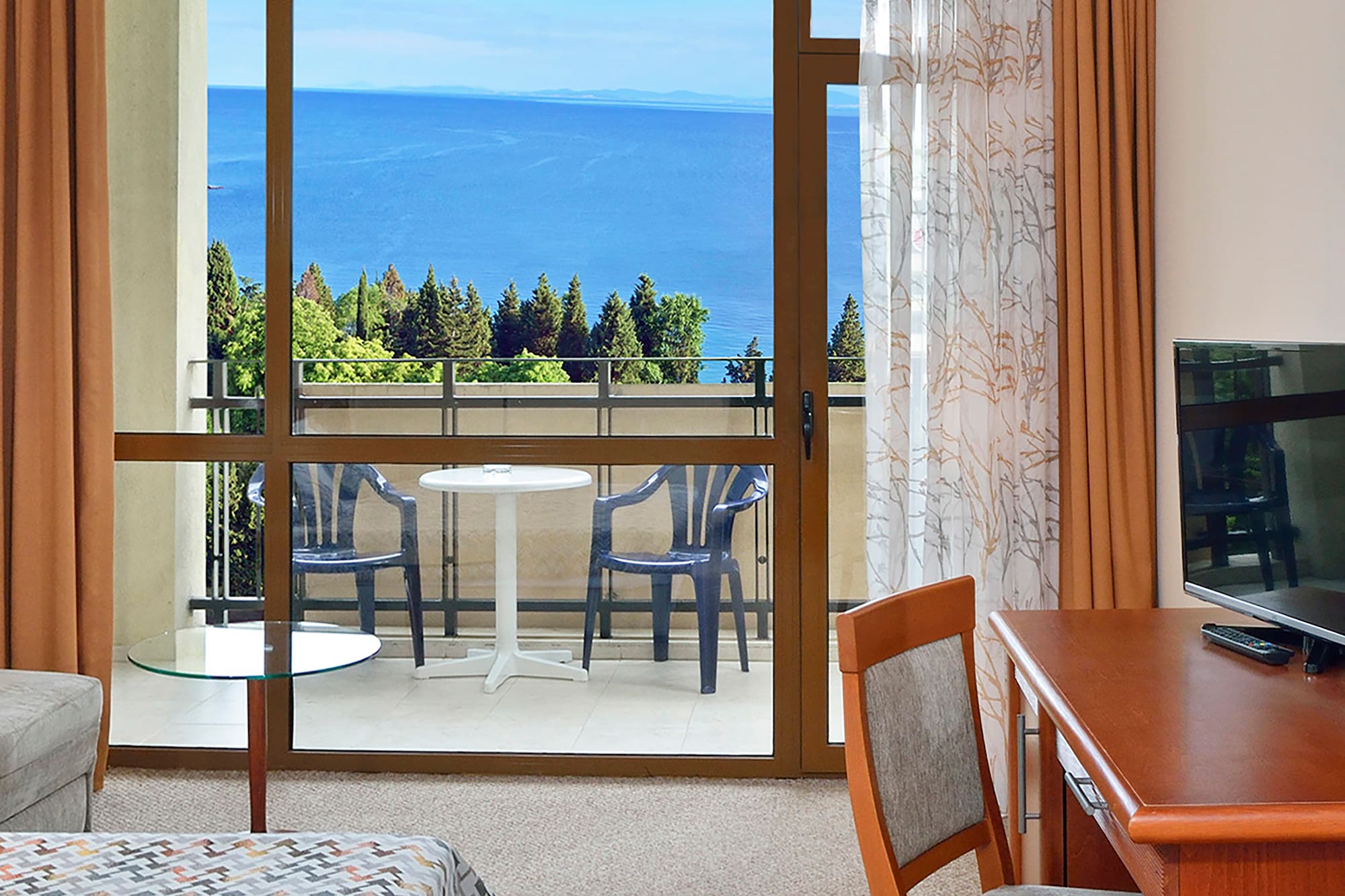 a room with a table and chairs and a television