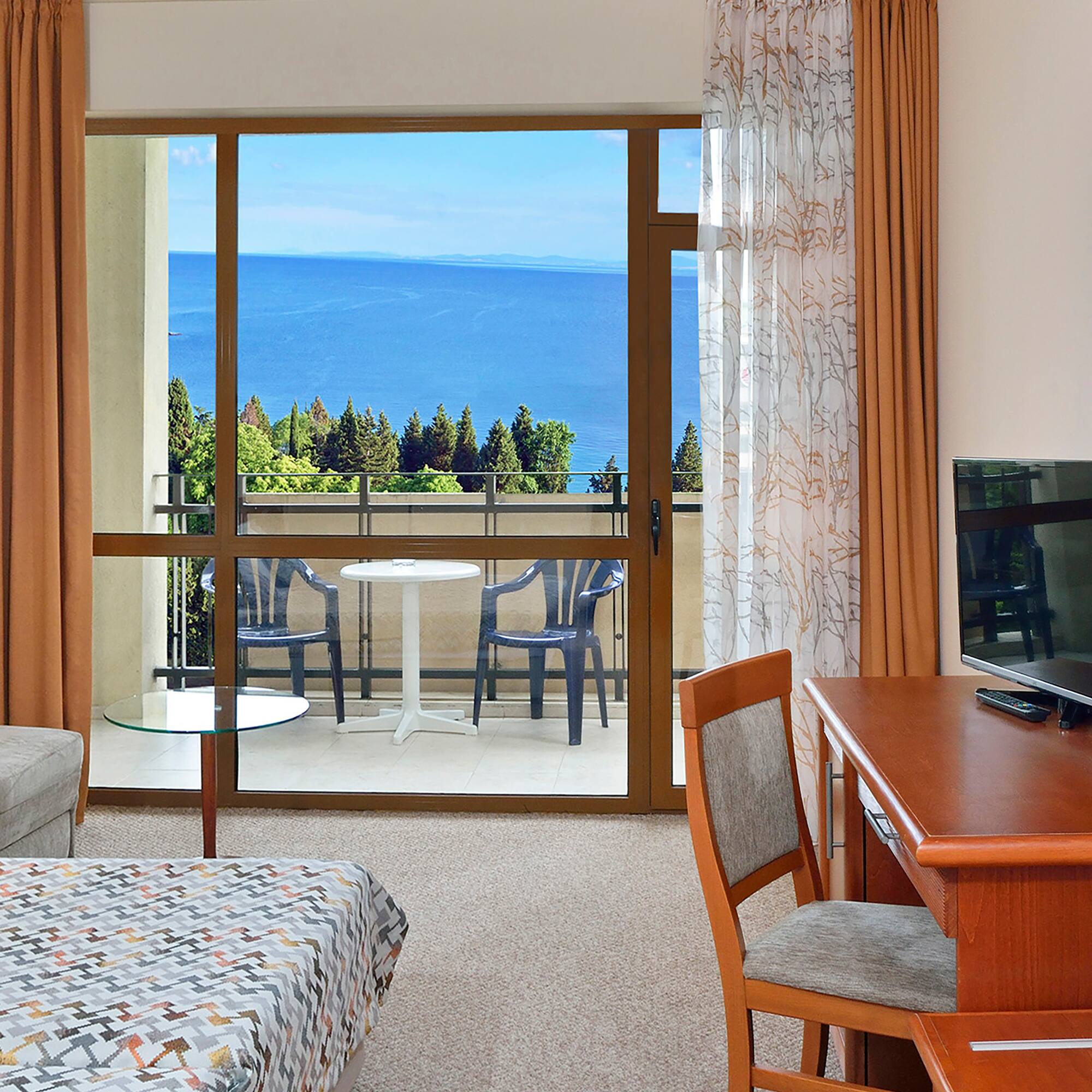 a room with a table and chairs and a television