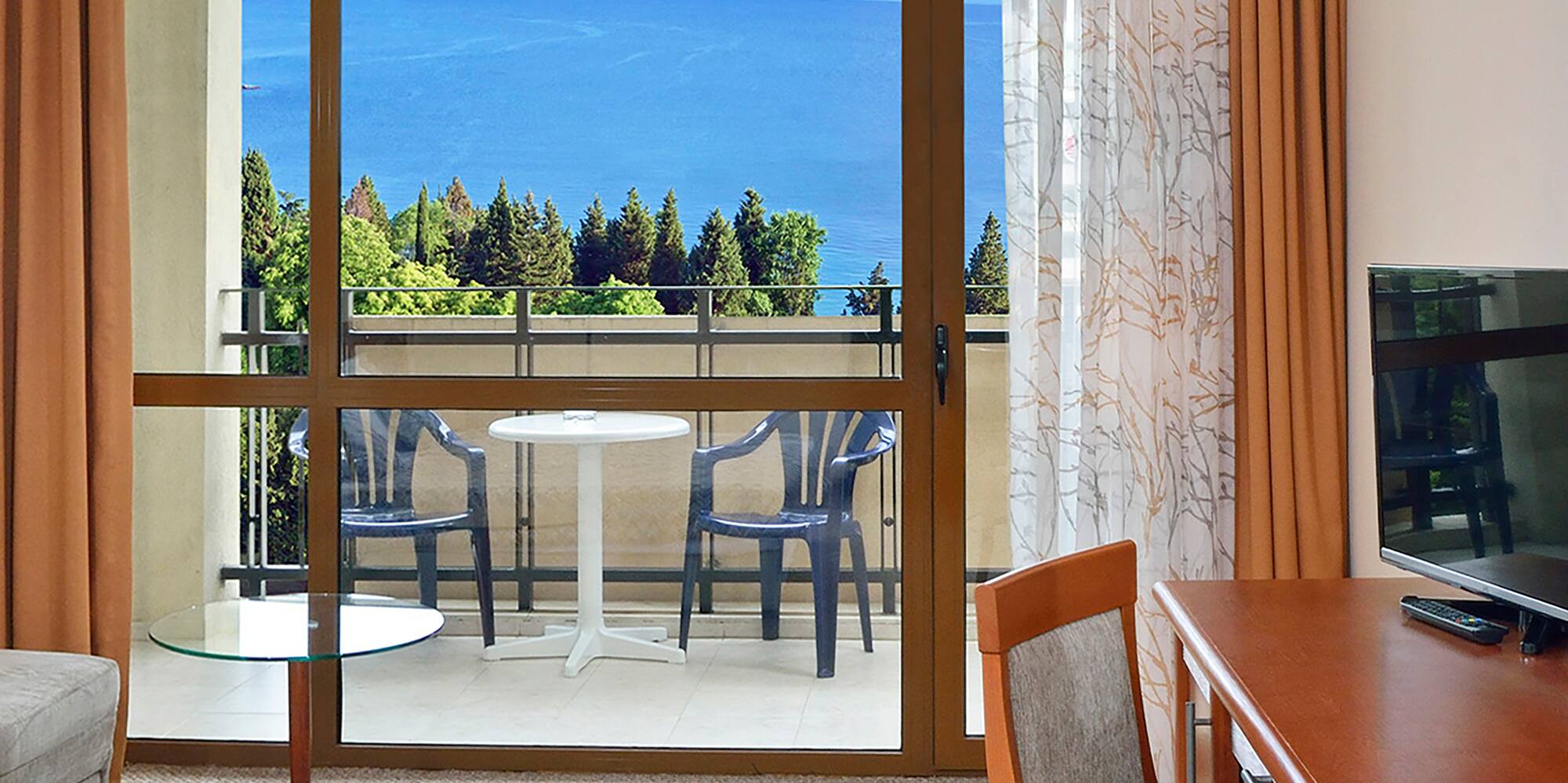 a room with a table and chairs and a television