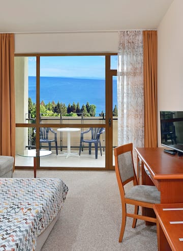 a room with a table and chairs and a television