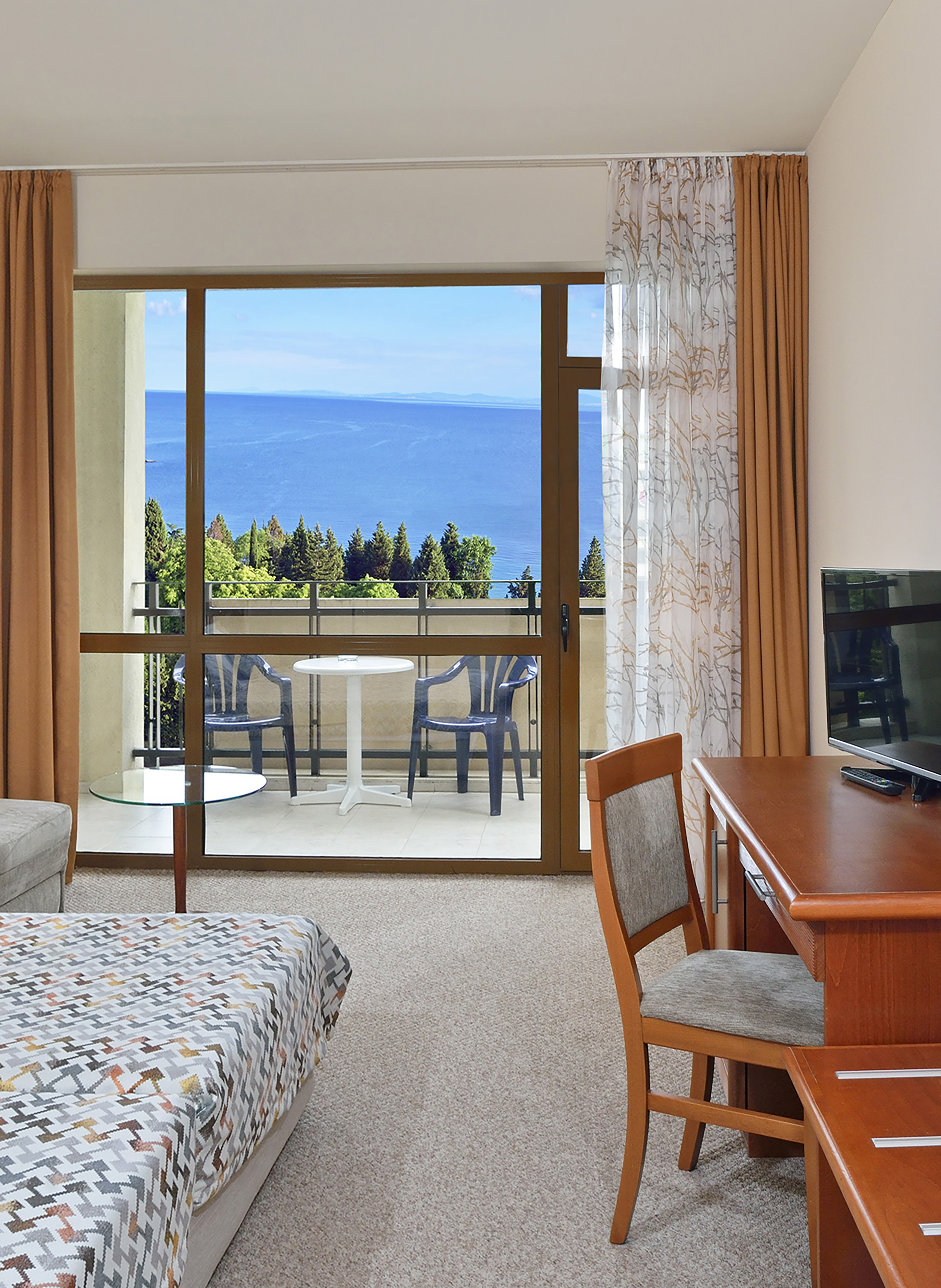 a room with a table and chairs and a television