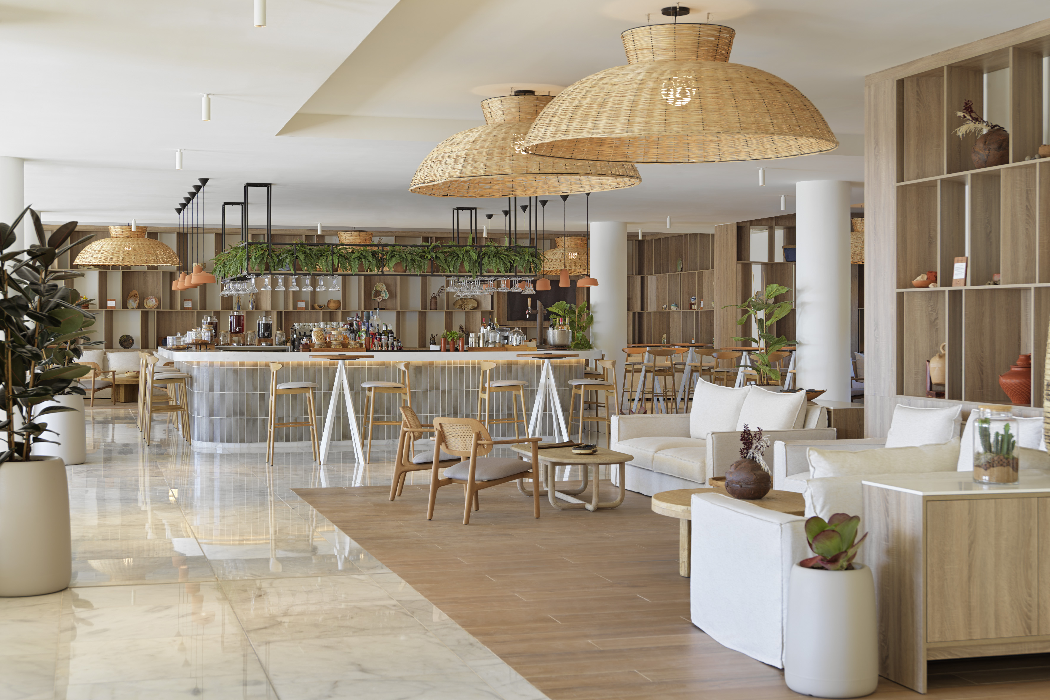Spacious hotel bar lounge with rattan pendant lights, wood accents.