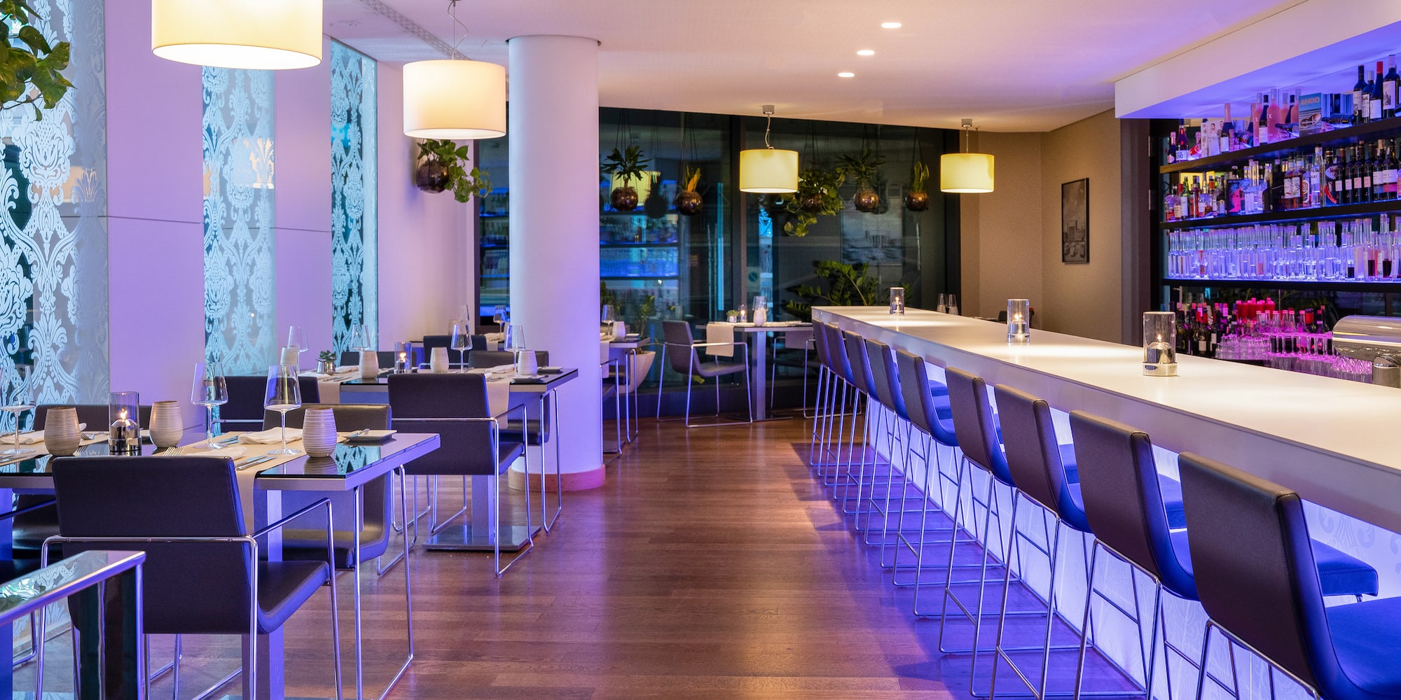 a long table with chairs and lights