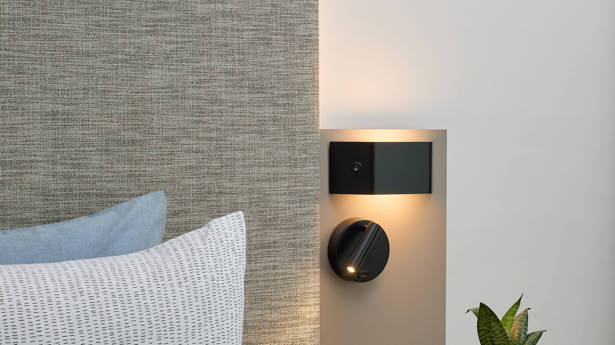 a small table with a plant on it next to a wall