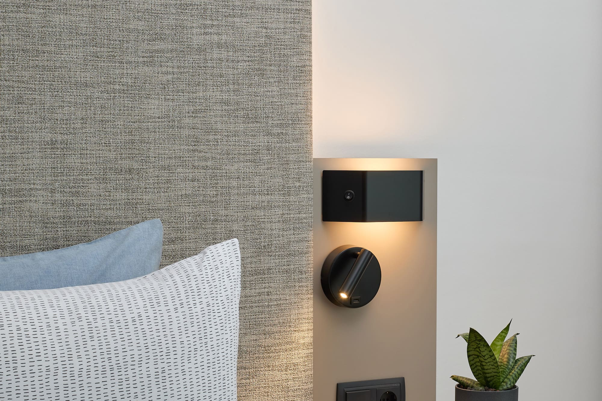 a small table with a plant on it next to a wall