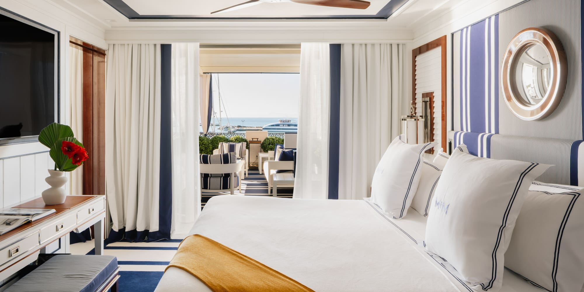 a room with a bed and a ceiling fan