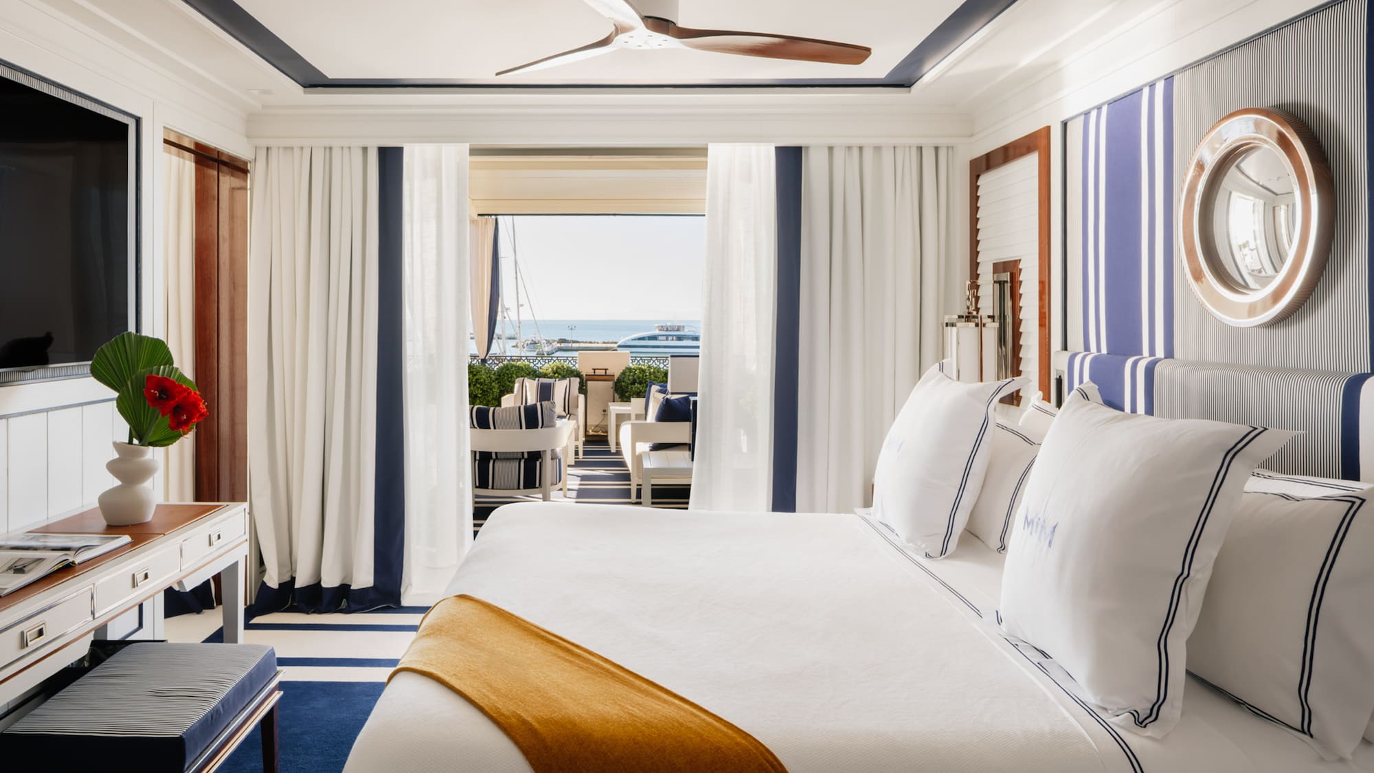 a room with a bed and a ceiling fan