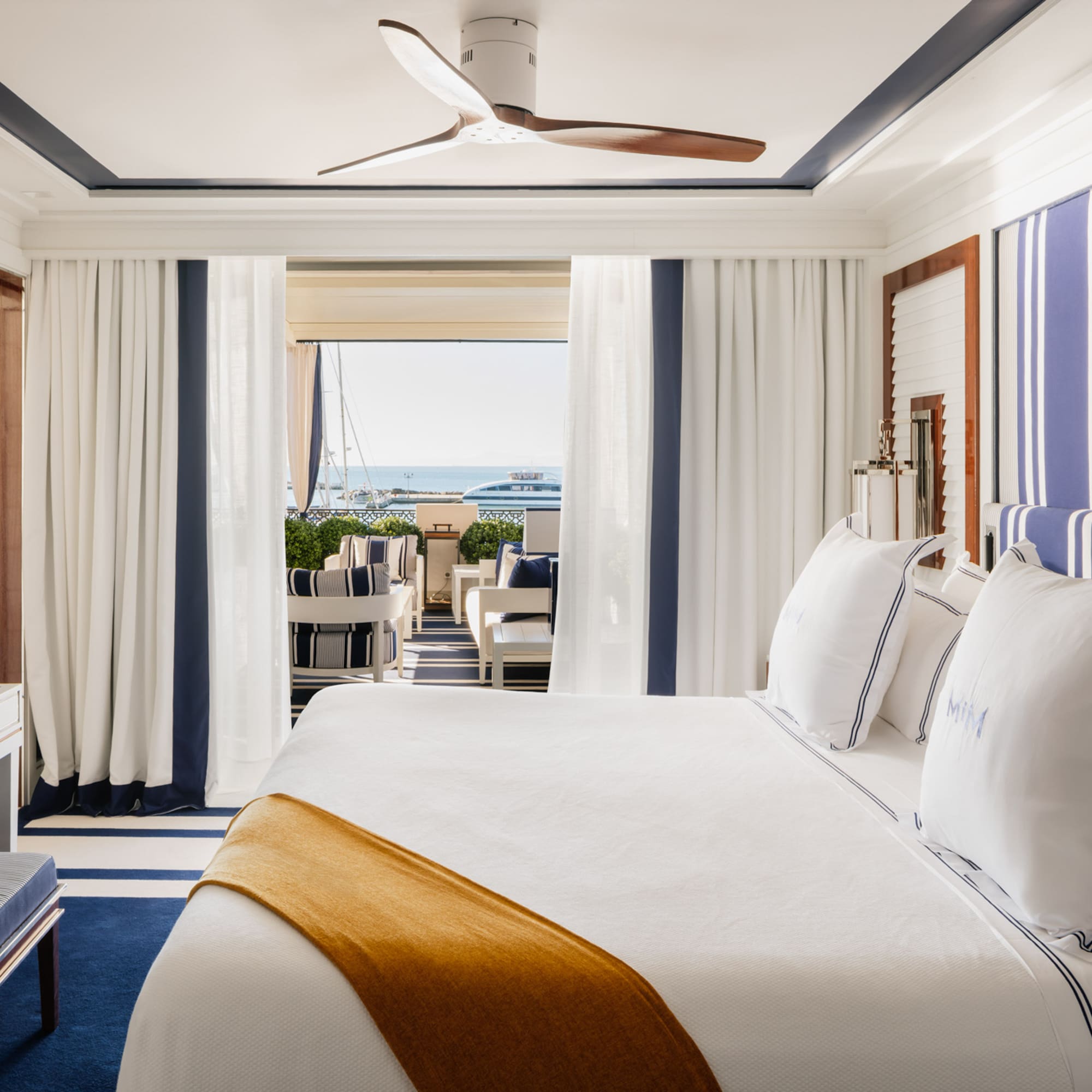 a room with a bed and a ceiling fan