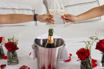 a couple of hands holding wine glasses