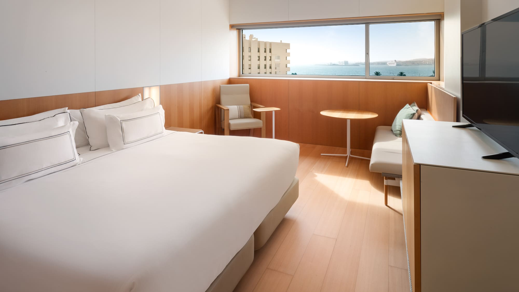 a room with a bed and chairs and a table