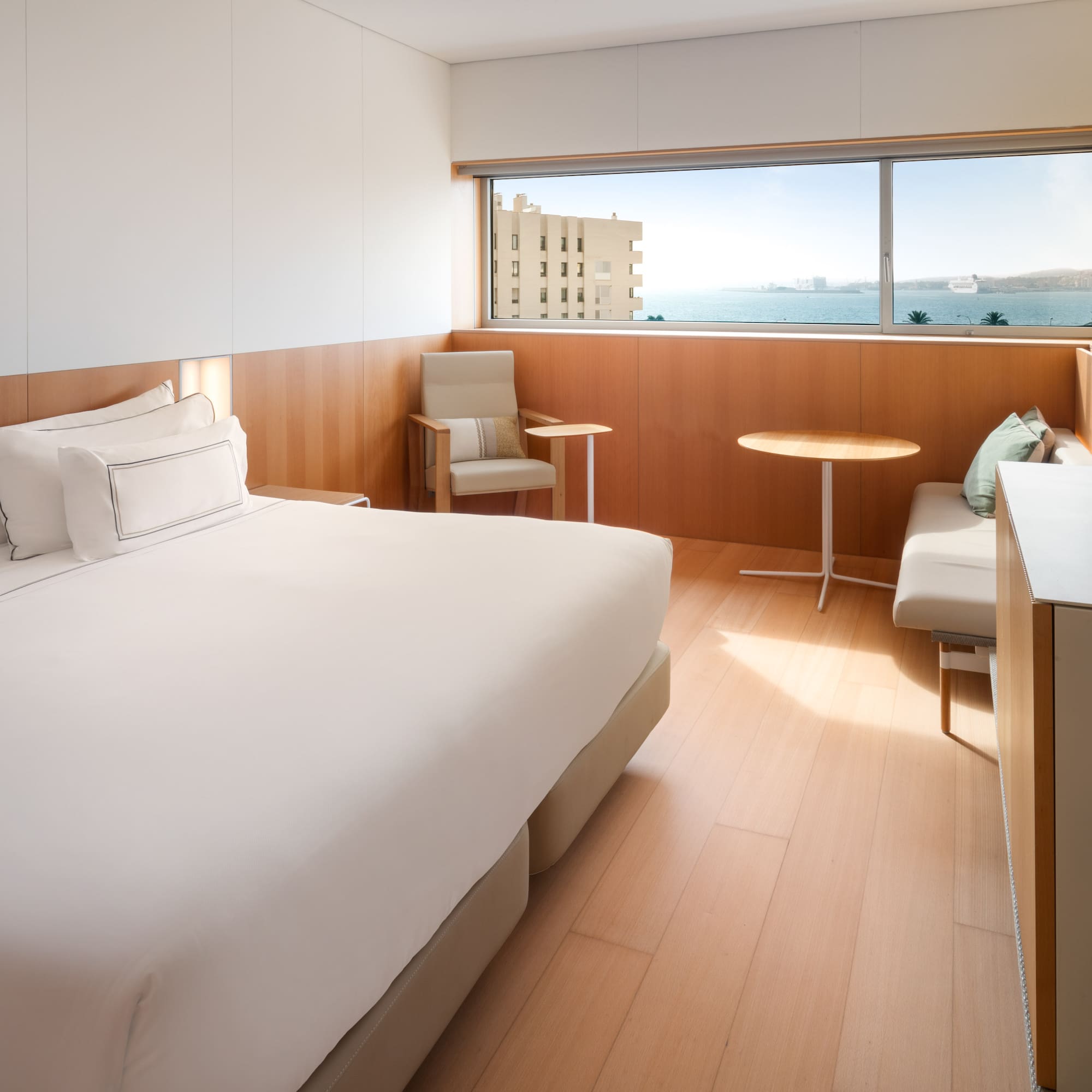 a room with a bed and chairs and a table