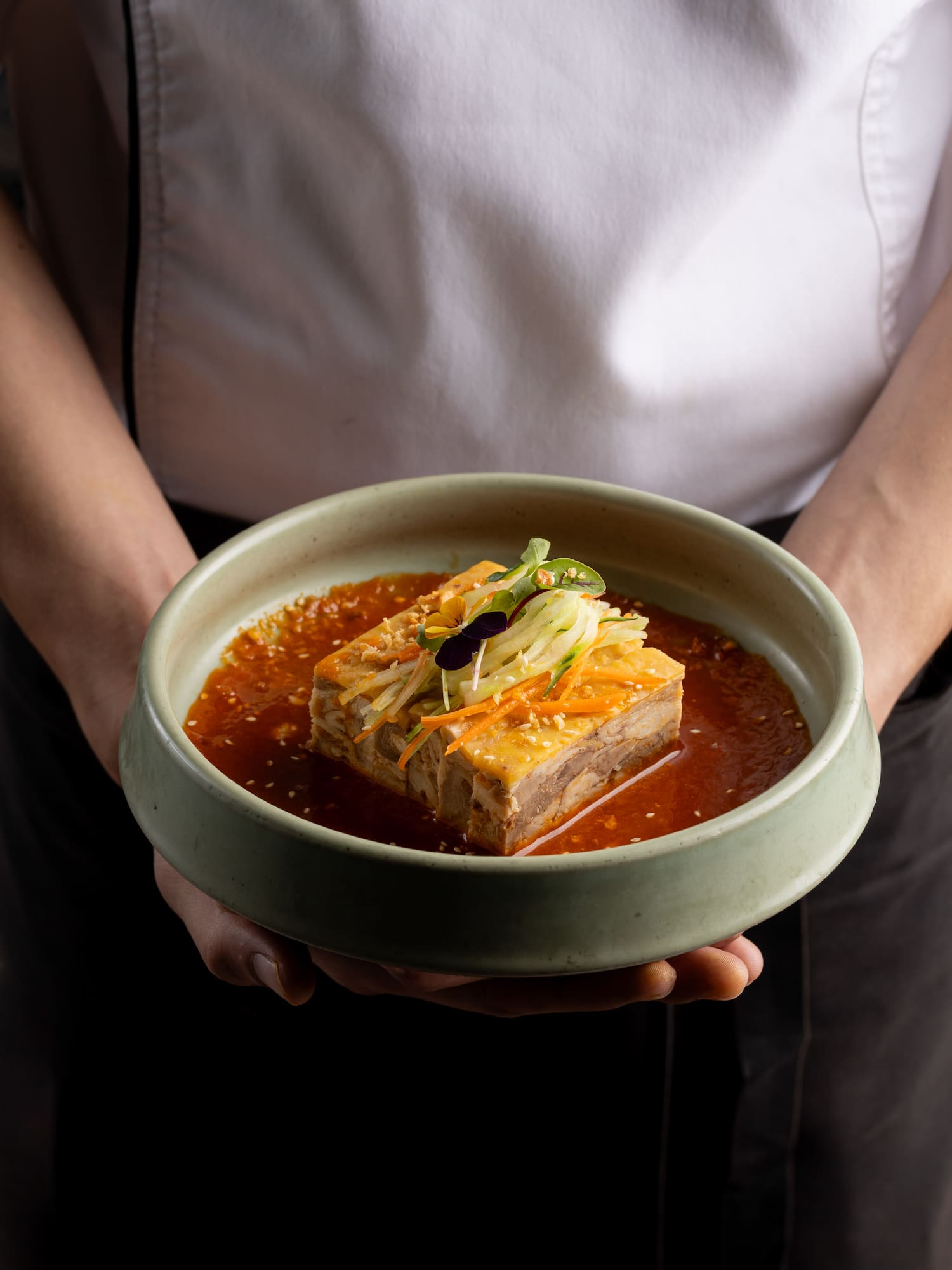 a person holding a bowl of food