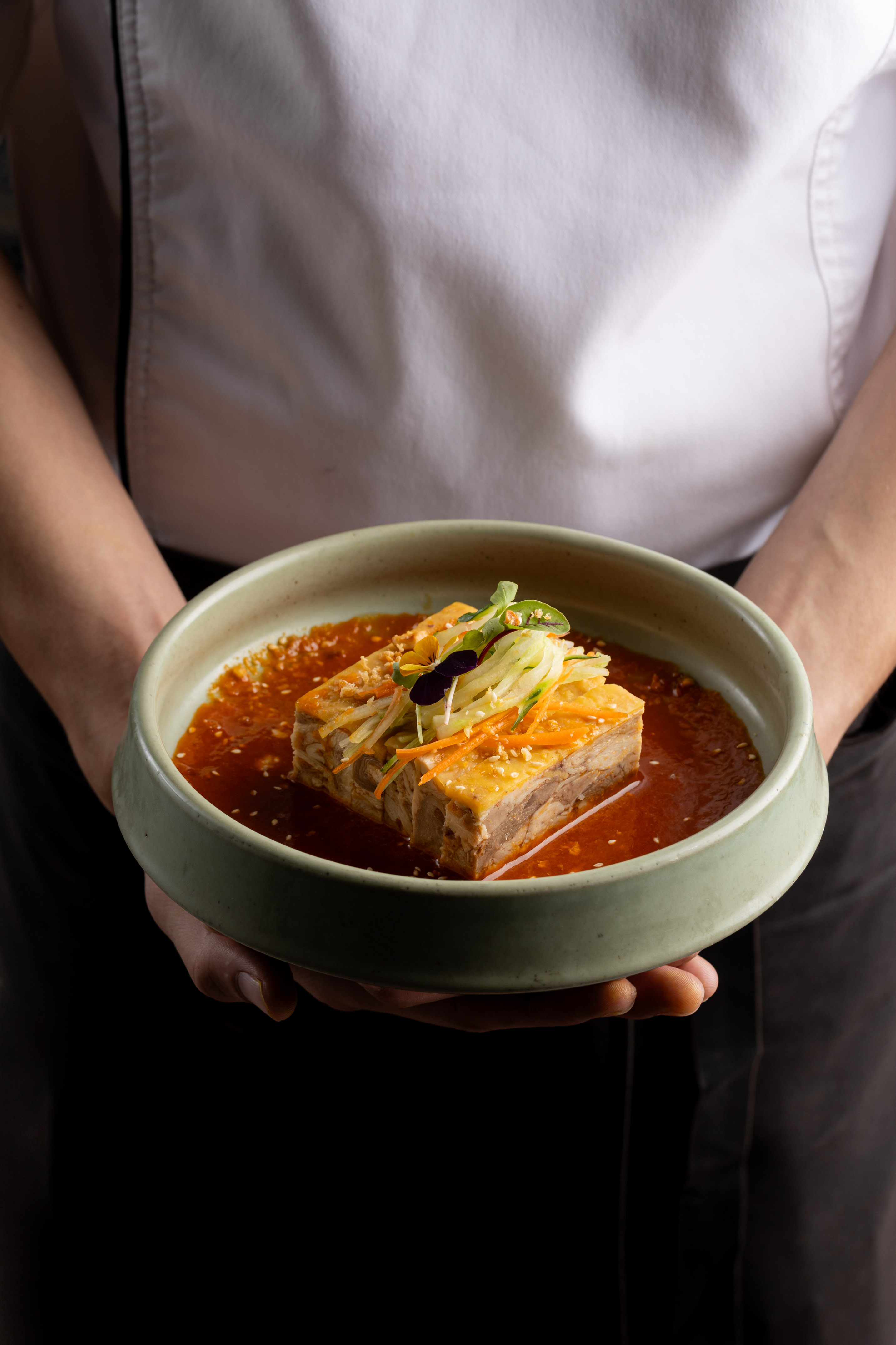 a person holding a bowl of food