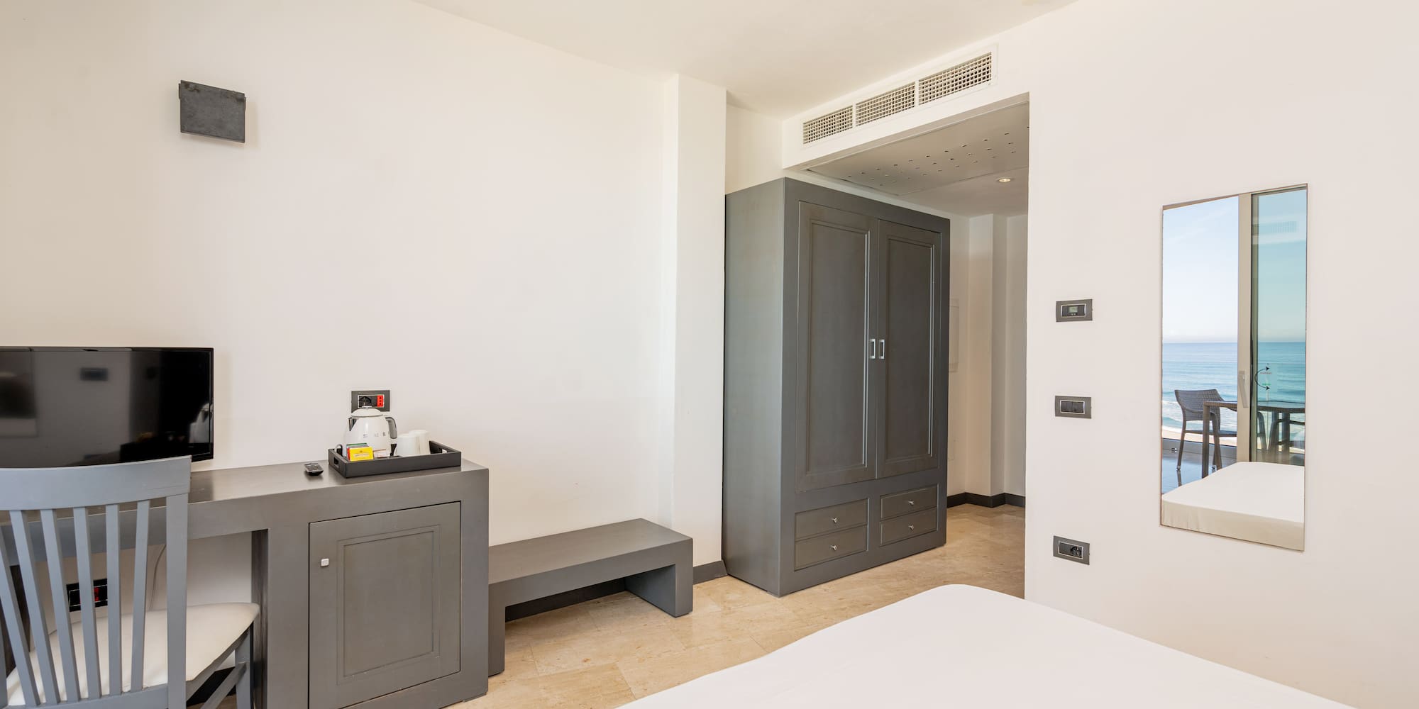 a room with a bed and a mirror