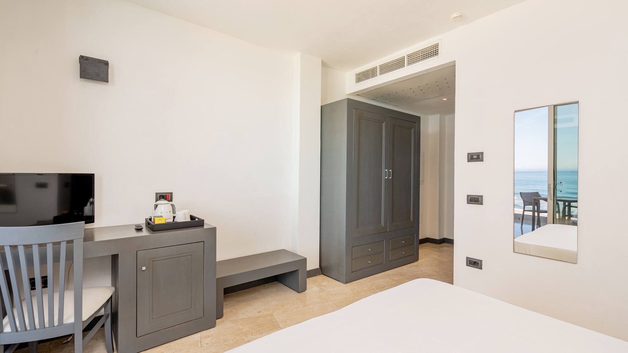 a room with a bed and a mirror