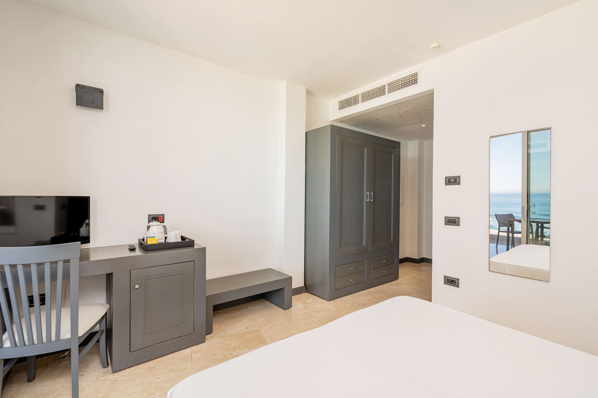 a room with a bed and a mirror