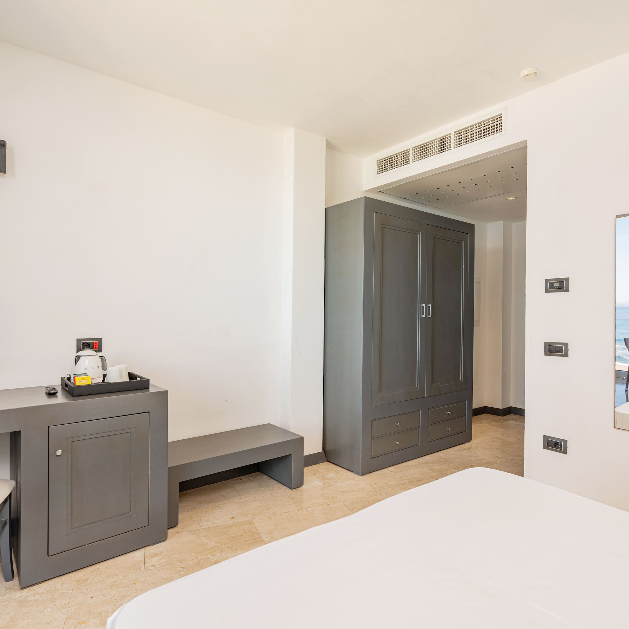 a room with a bed and a mirror