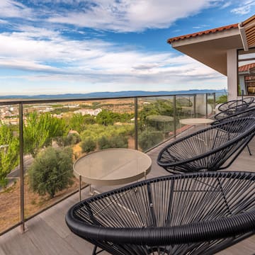 a patio with chairs and a table