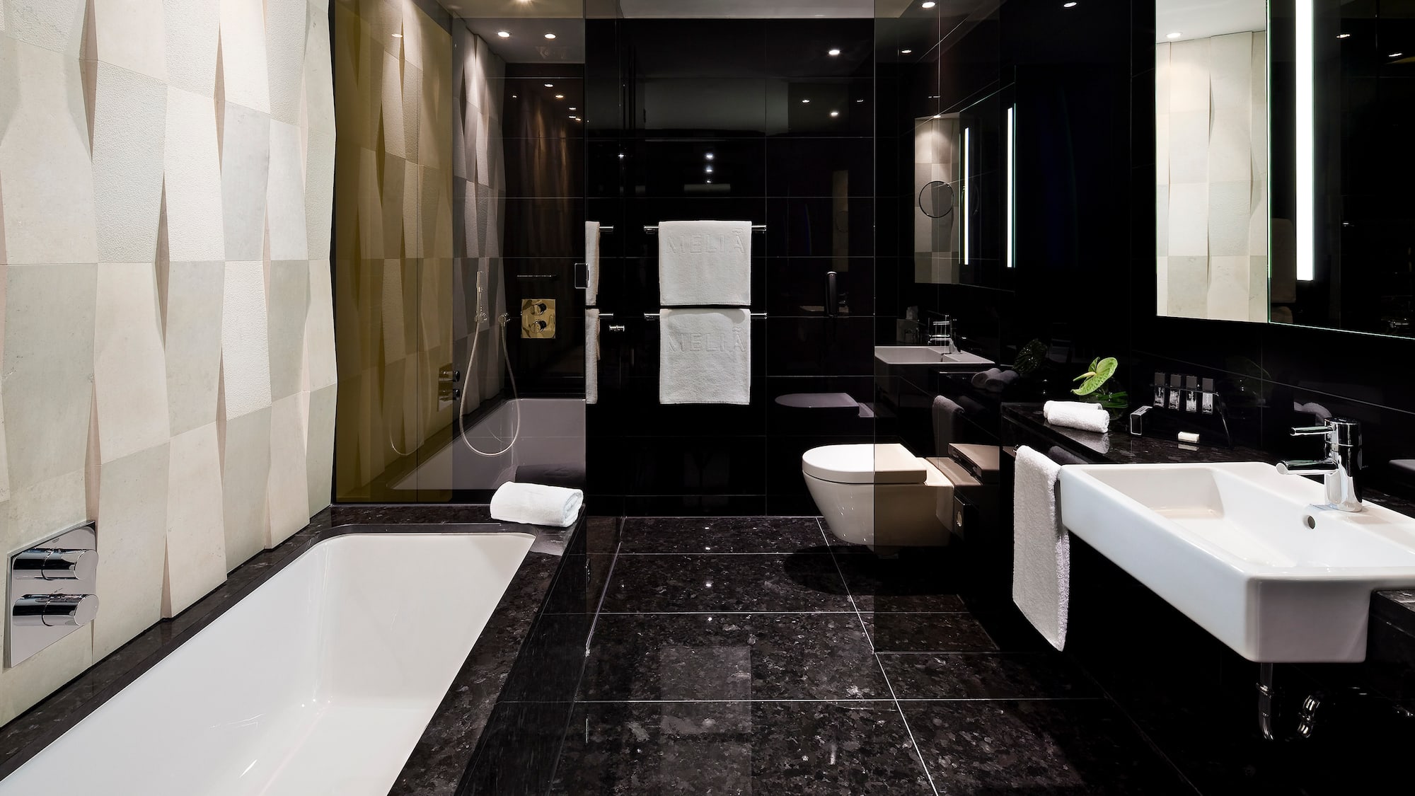 a bathroom with a black tile floor