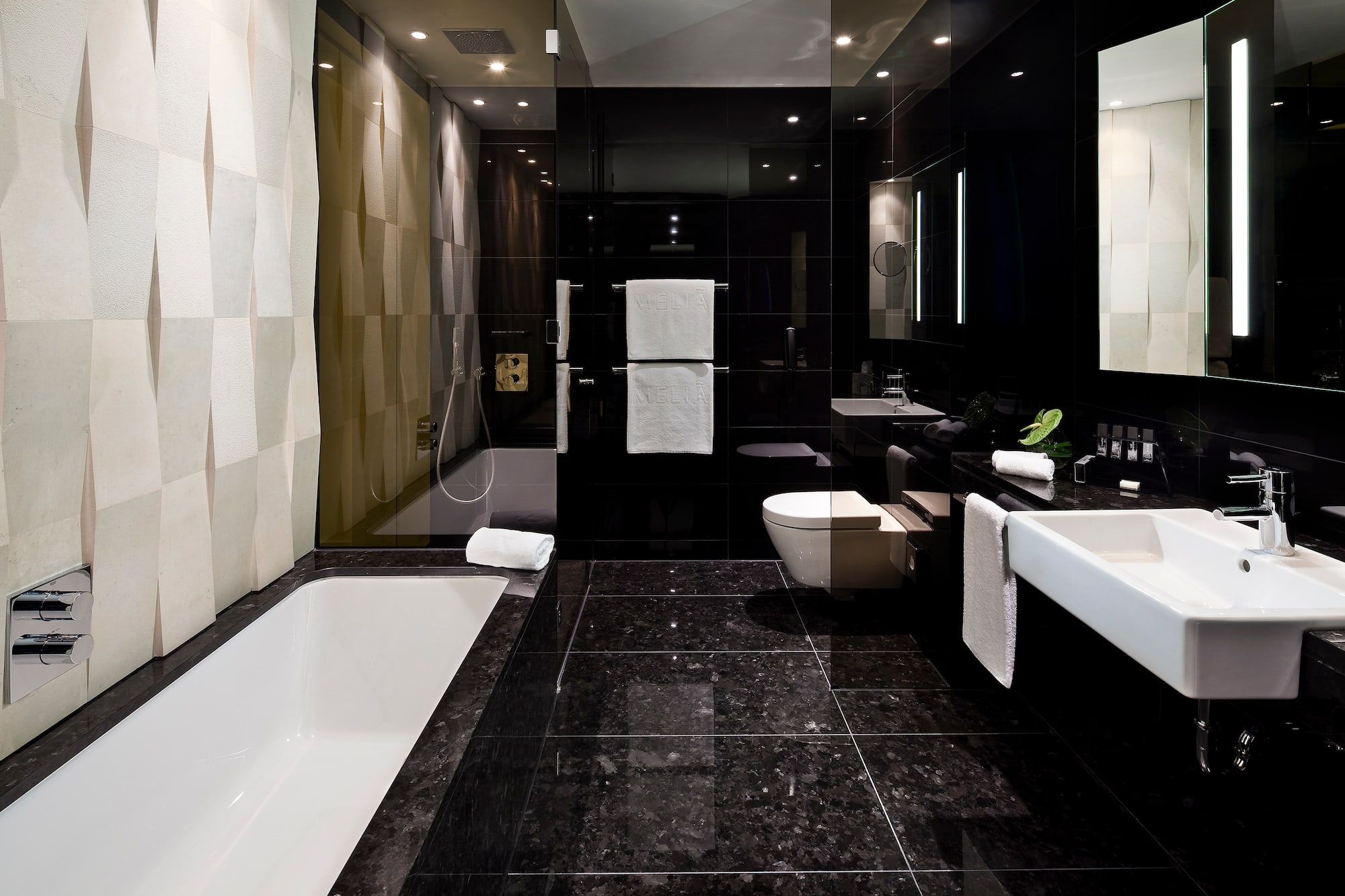 a bathroom with a black tile floor