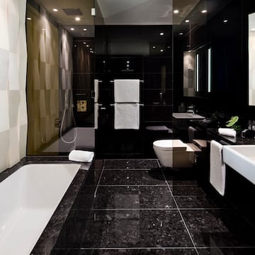 a bathroom with a black tile floor