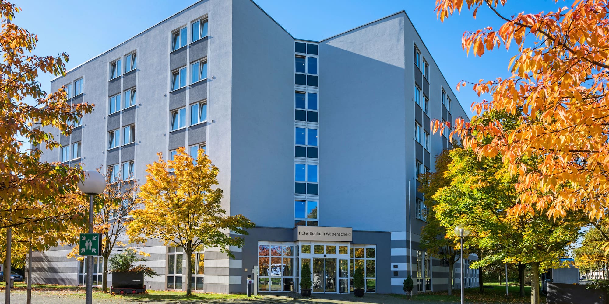 a building with trees and a driveway