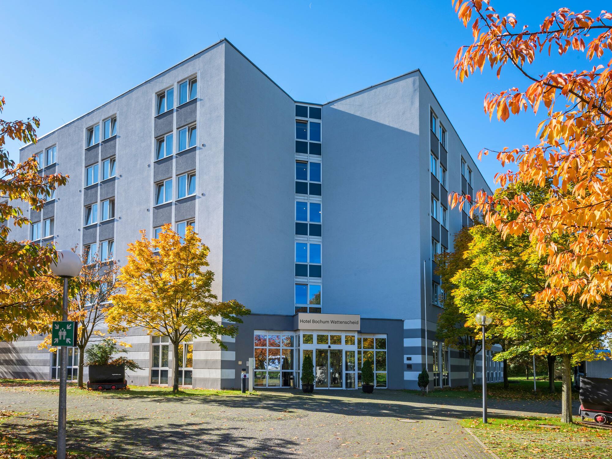 a building with trees and a driveway