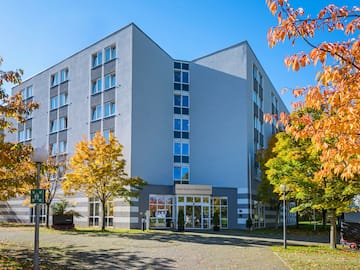 a building with trees and a driveway