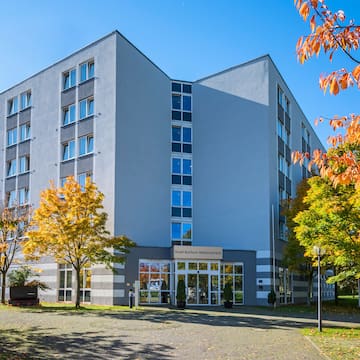 a building with trees and a driveway