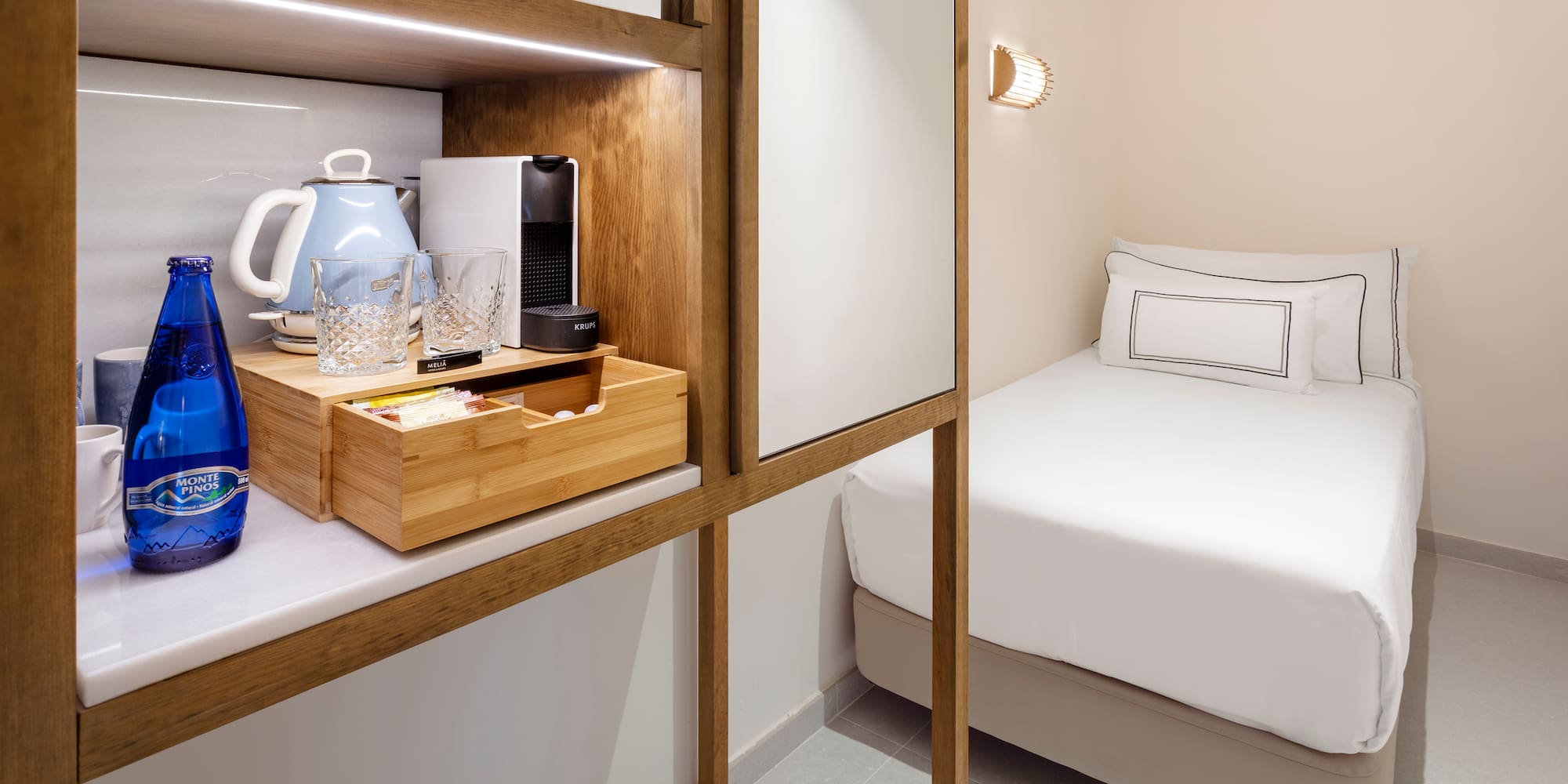 a room with a bed and a coffee maker