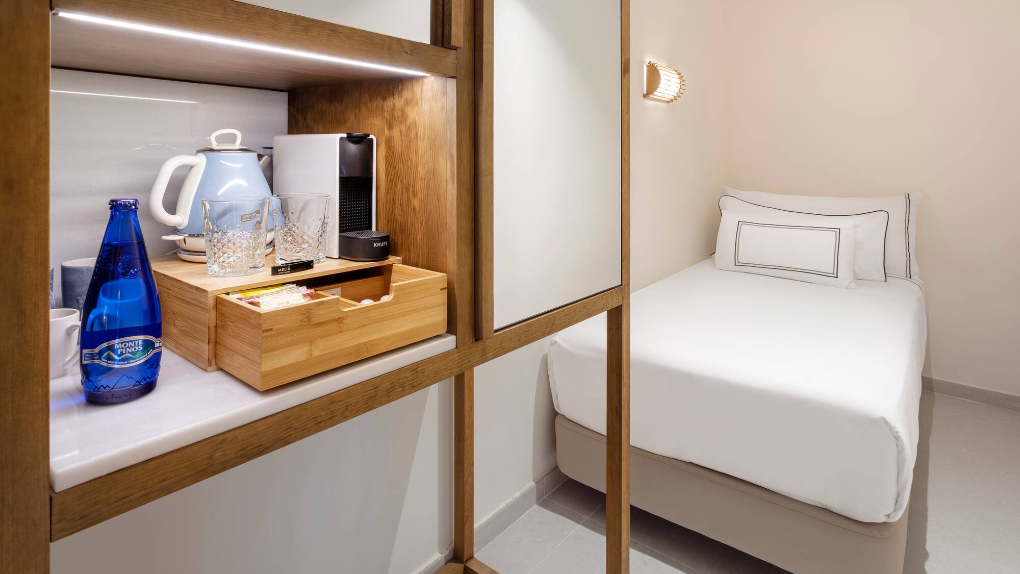 a room with a bed and a coffee maker