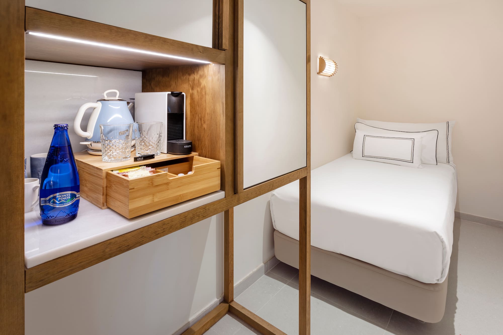 a room with a bed and a coffee maker