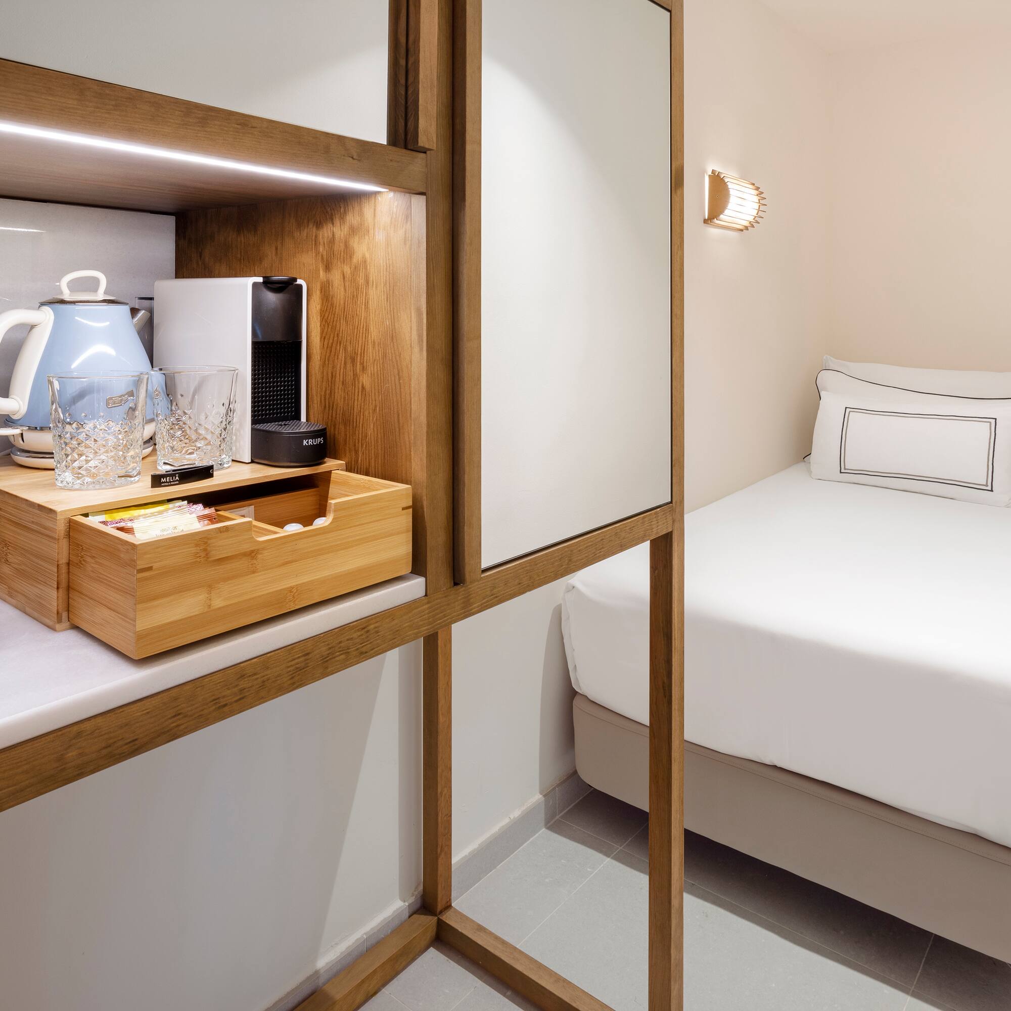 a room with a bed and a coffee maker