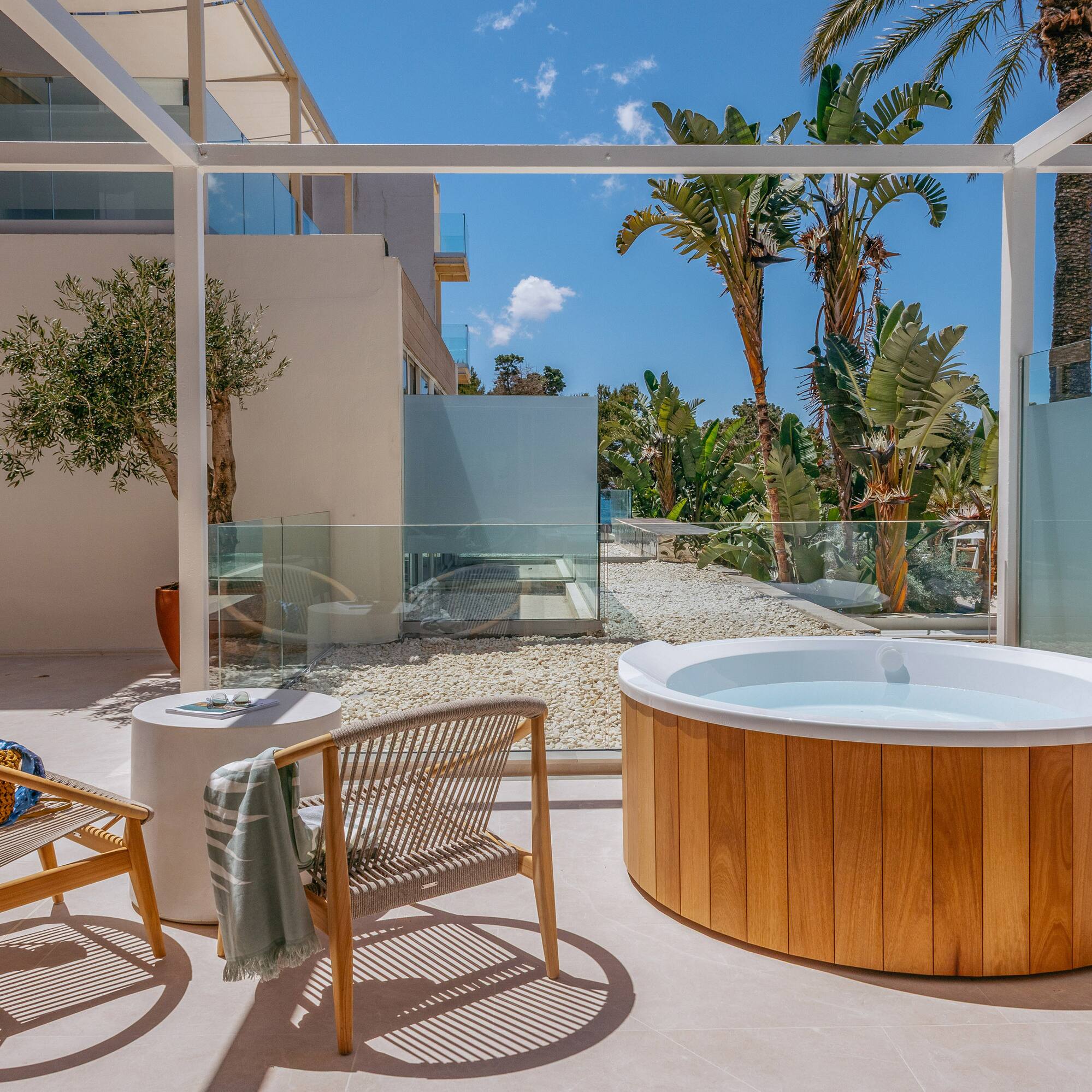 a hot tub and chair on a patio