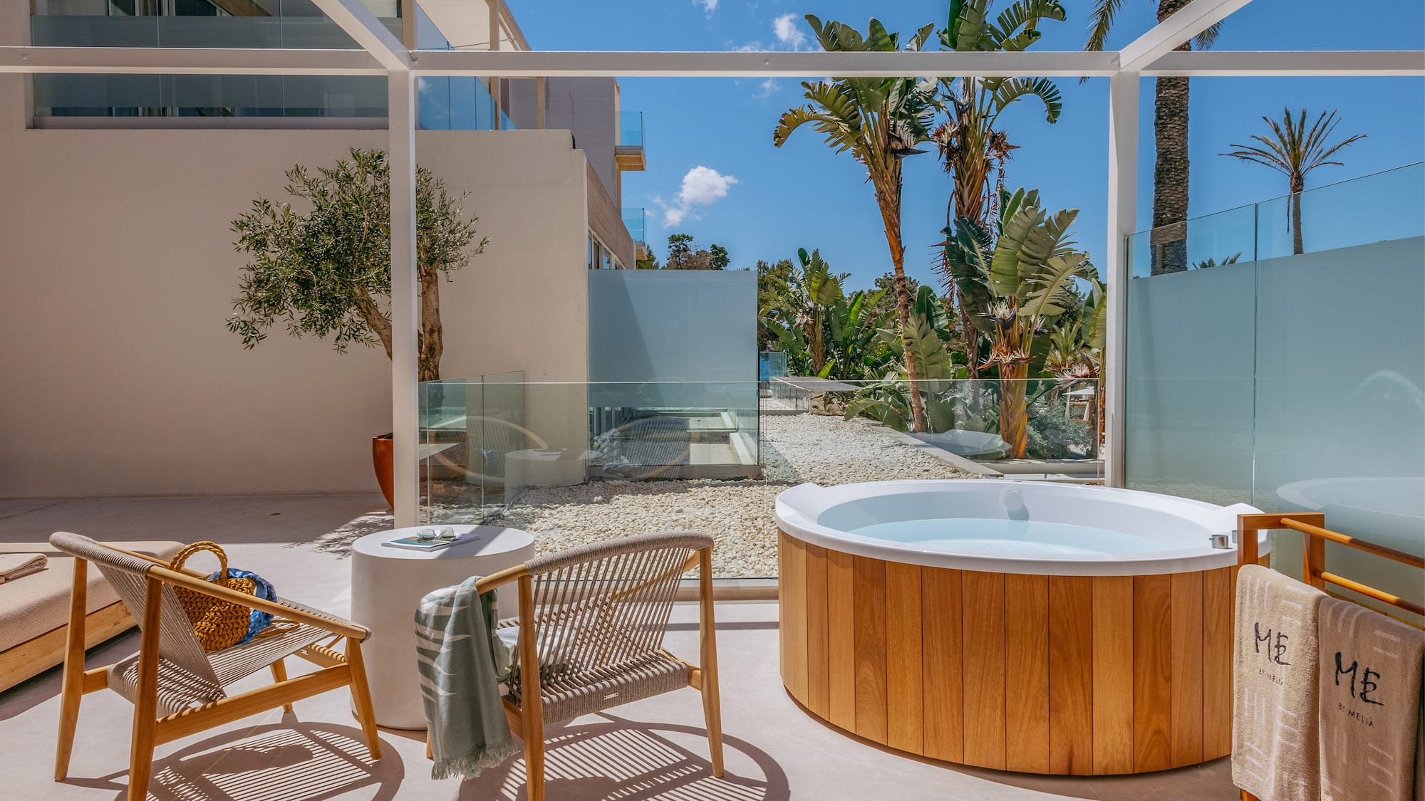 a hot tub and chair on a patio