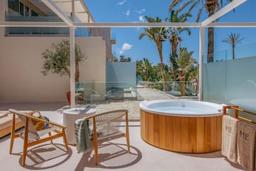 a hot tub and chair on a patio