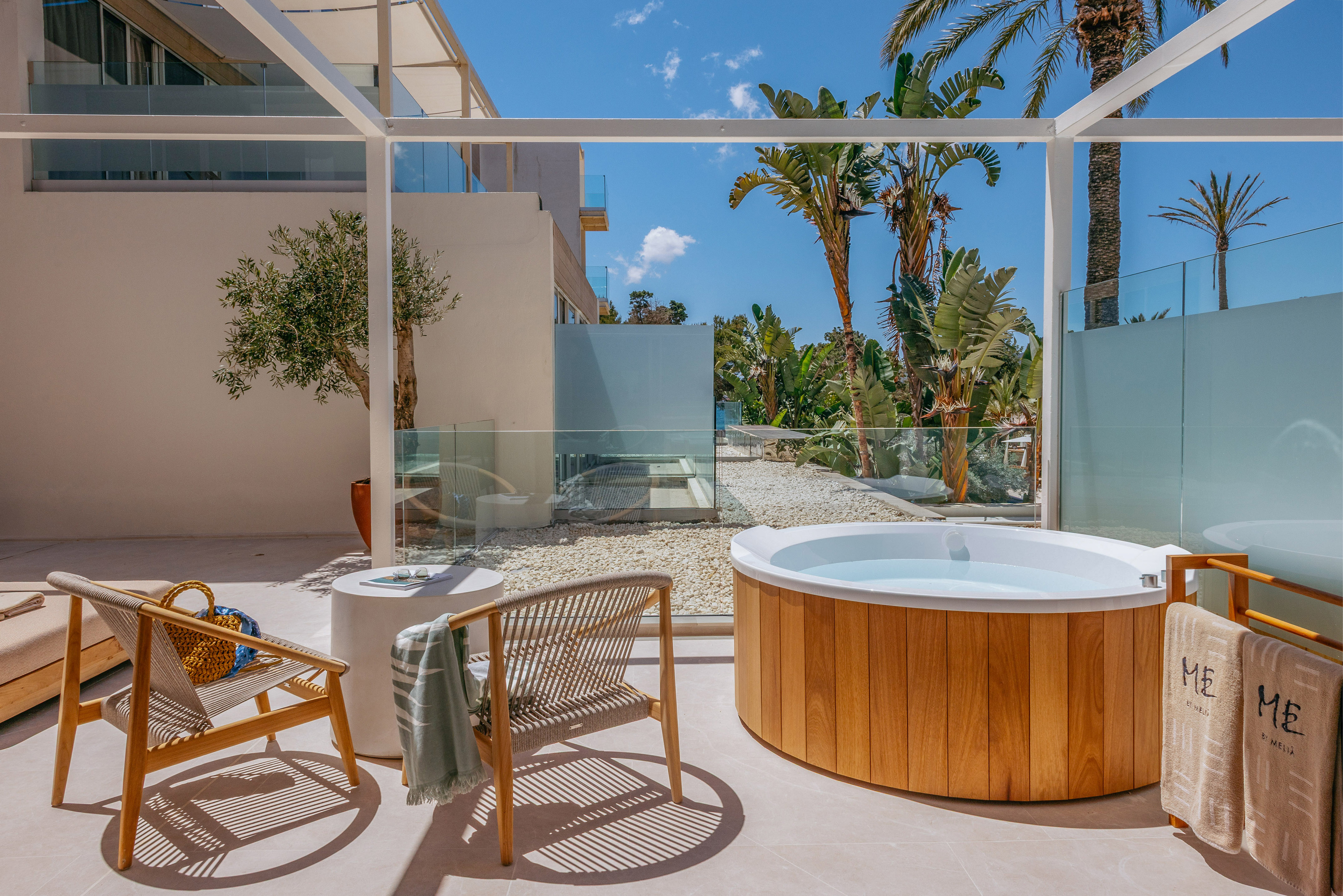a hot tub and chair on a patio