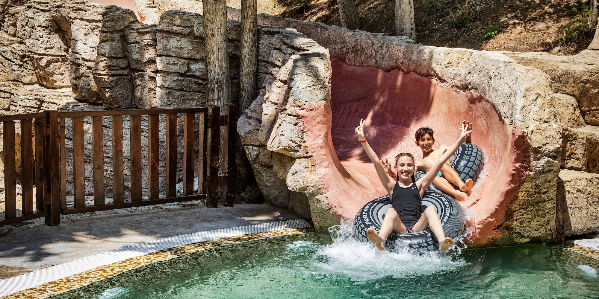 two girls on a tube in a pool