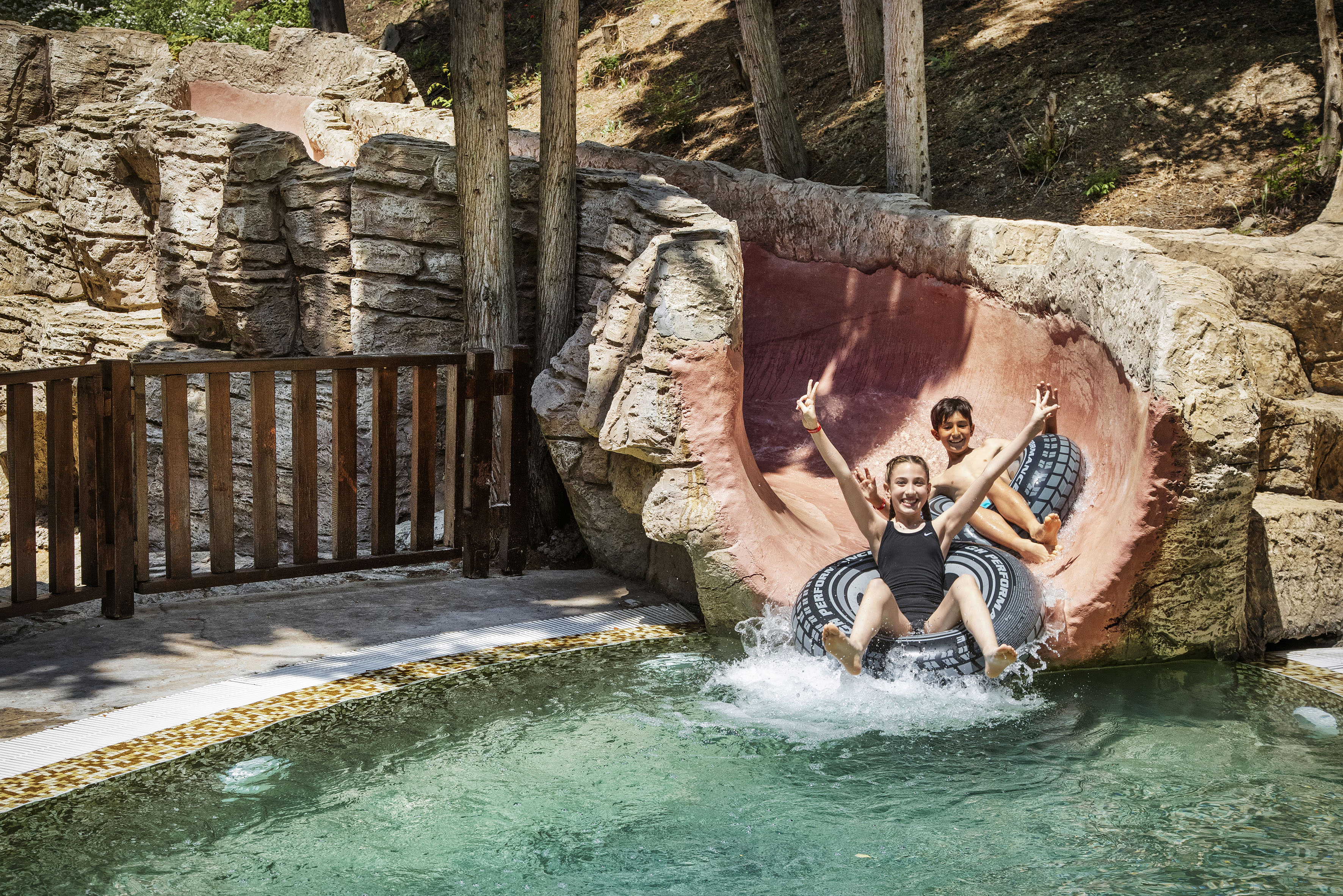 two girls on a tube in a pool