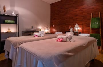 a massage room with towels and towels on the bed
