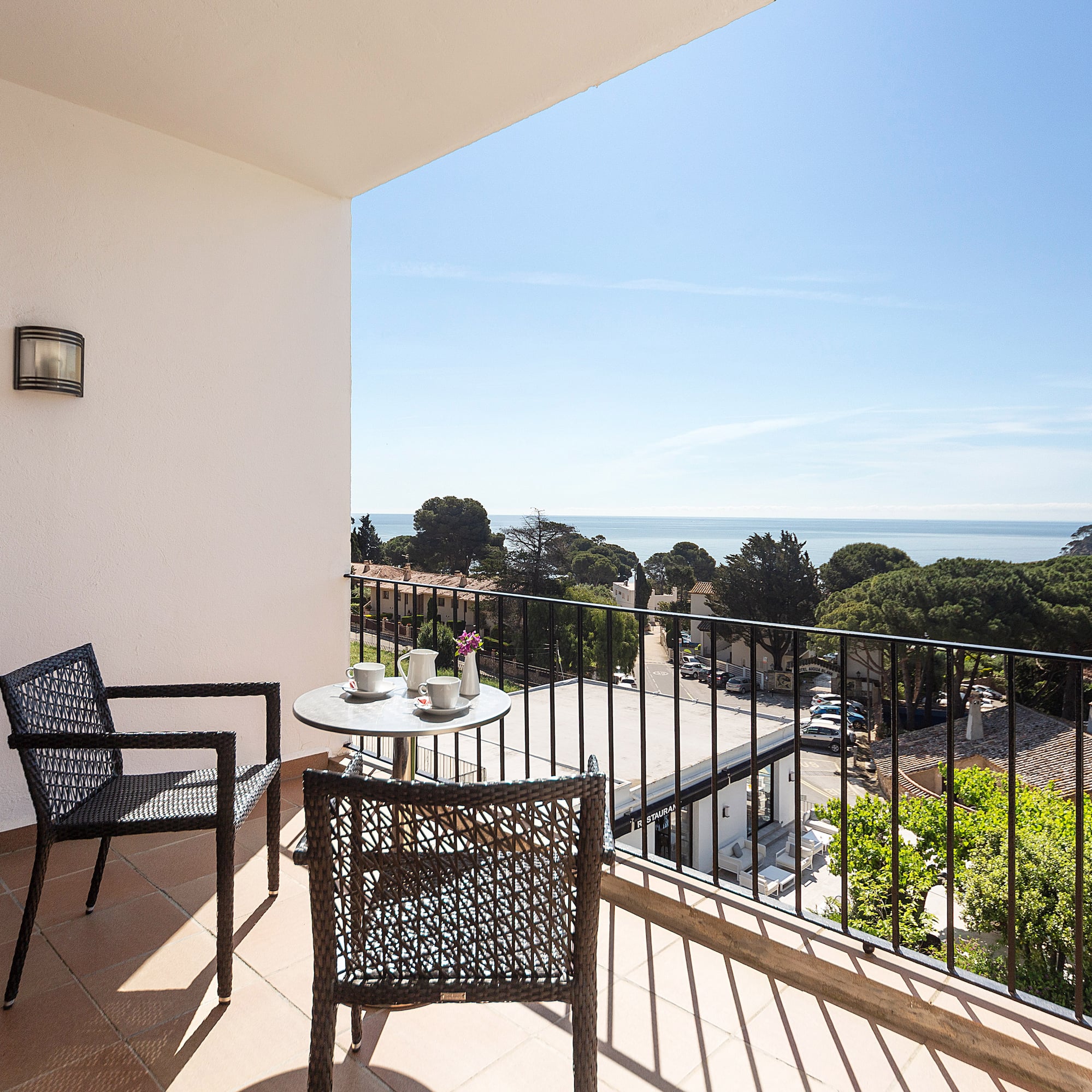 a balcony with chairs and a table