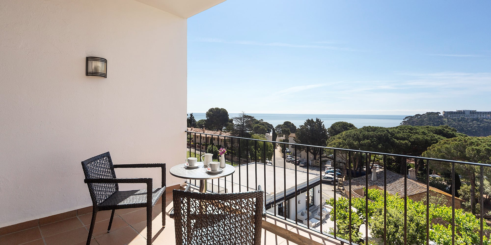 a balcony with chairs and a table