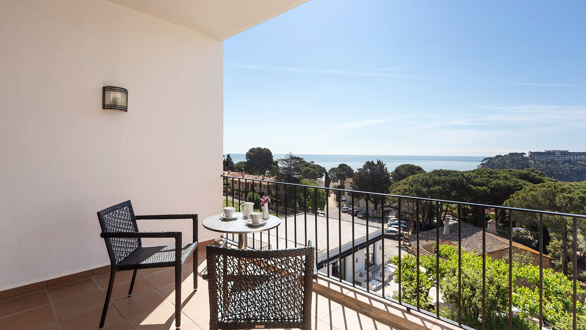 a balcony with chairs and a table