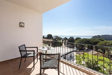 a balcony with chairs and a table